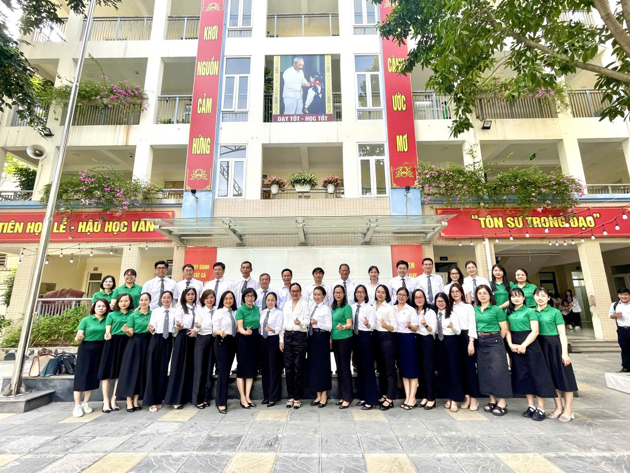 A group of people standing in front of a buildingDescription automatically generated