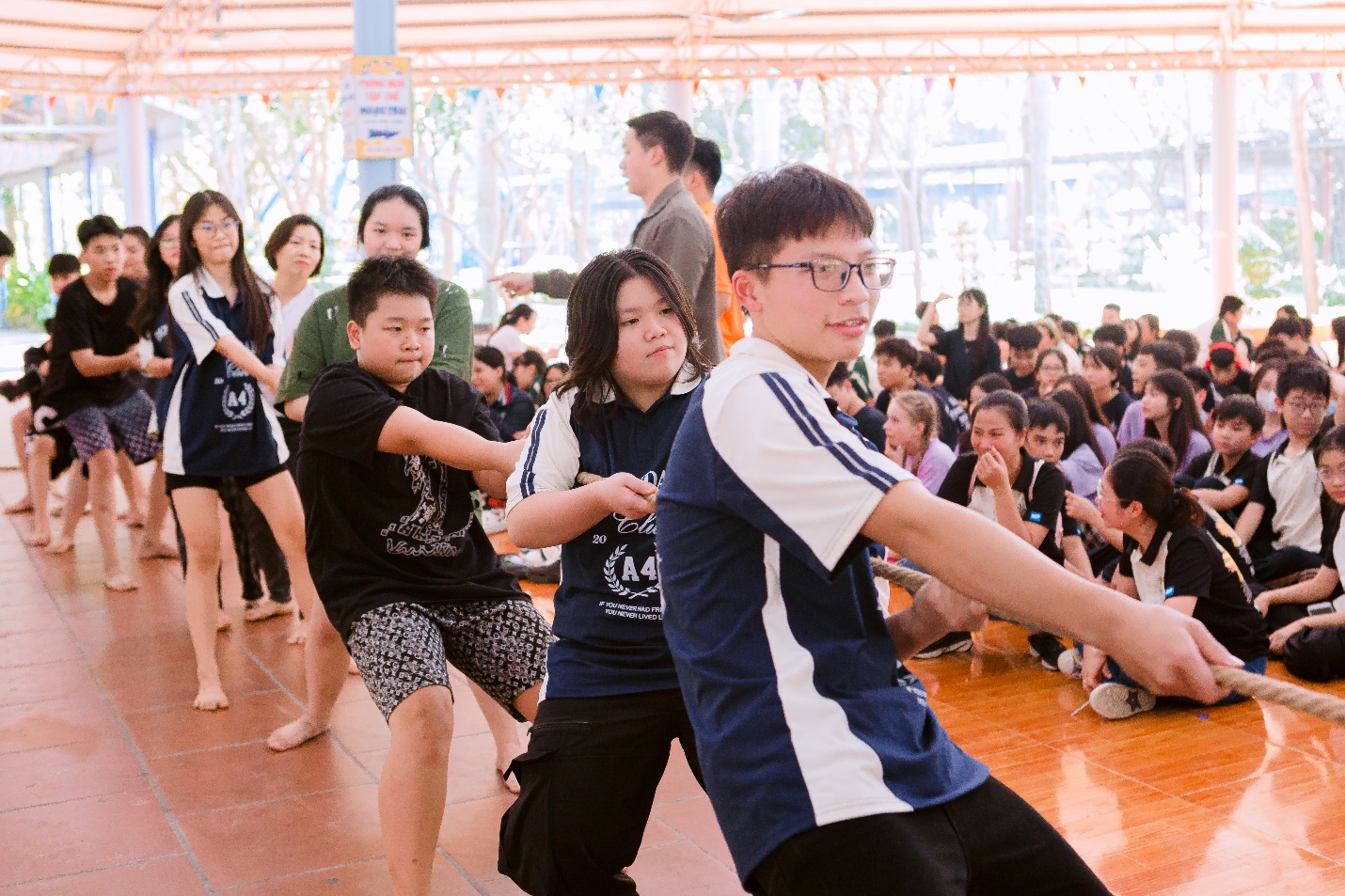 A group of people dancing in a roomDescription automatically generated