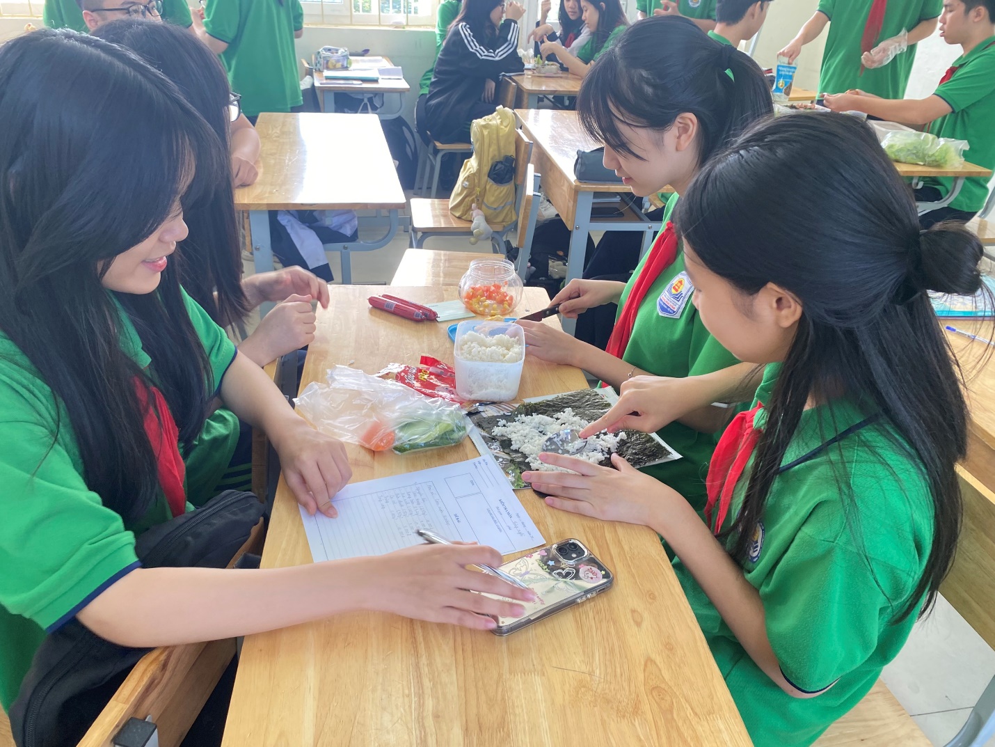 A group of girls sitting at a table

Description automatically generated