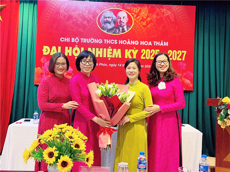 A group of women in dresses posing for a photoDescription automatically generated
