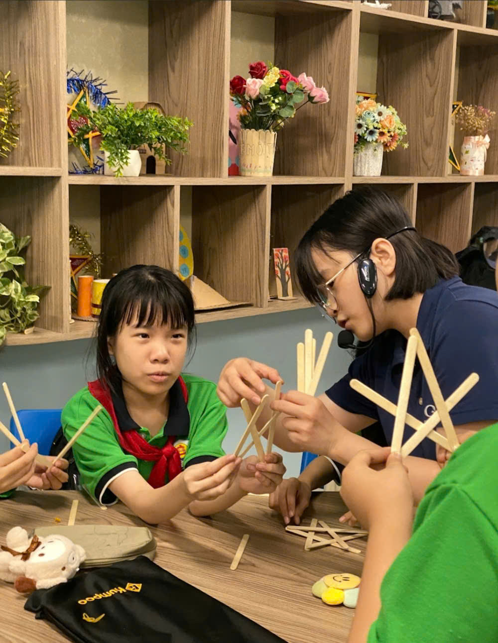 A group of kids making a craftDescription automatically generated