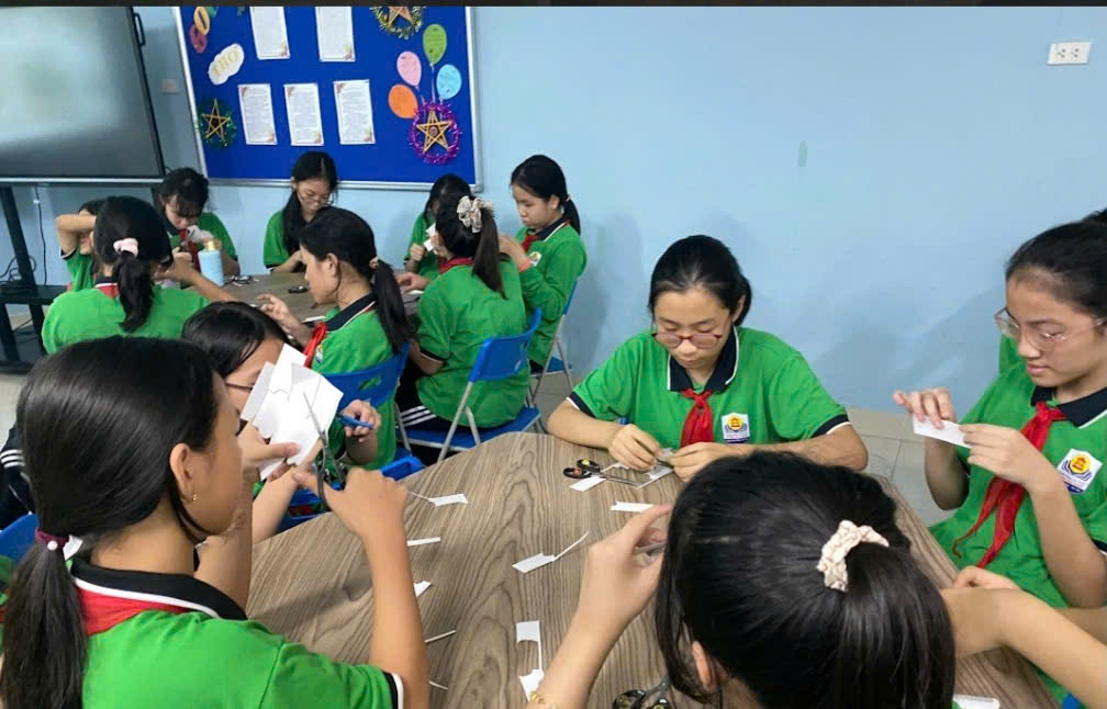 A group of girls sitting at a tableDescription automatically generated