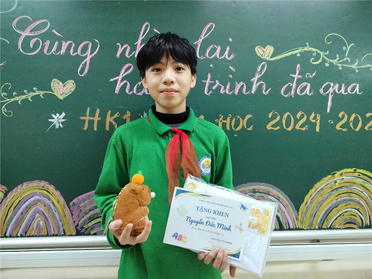 A child holding a stuffed animal and a certificate in front of a chalkboard

Description automatically generated
