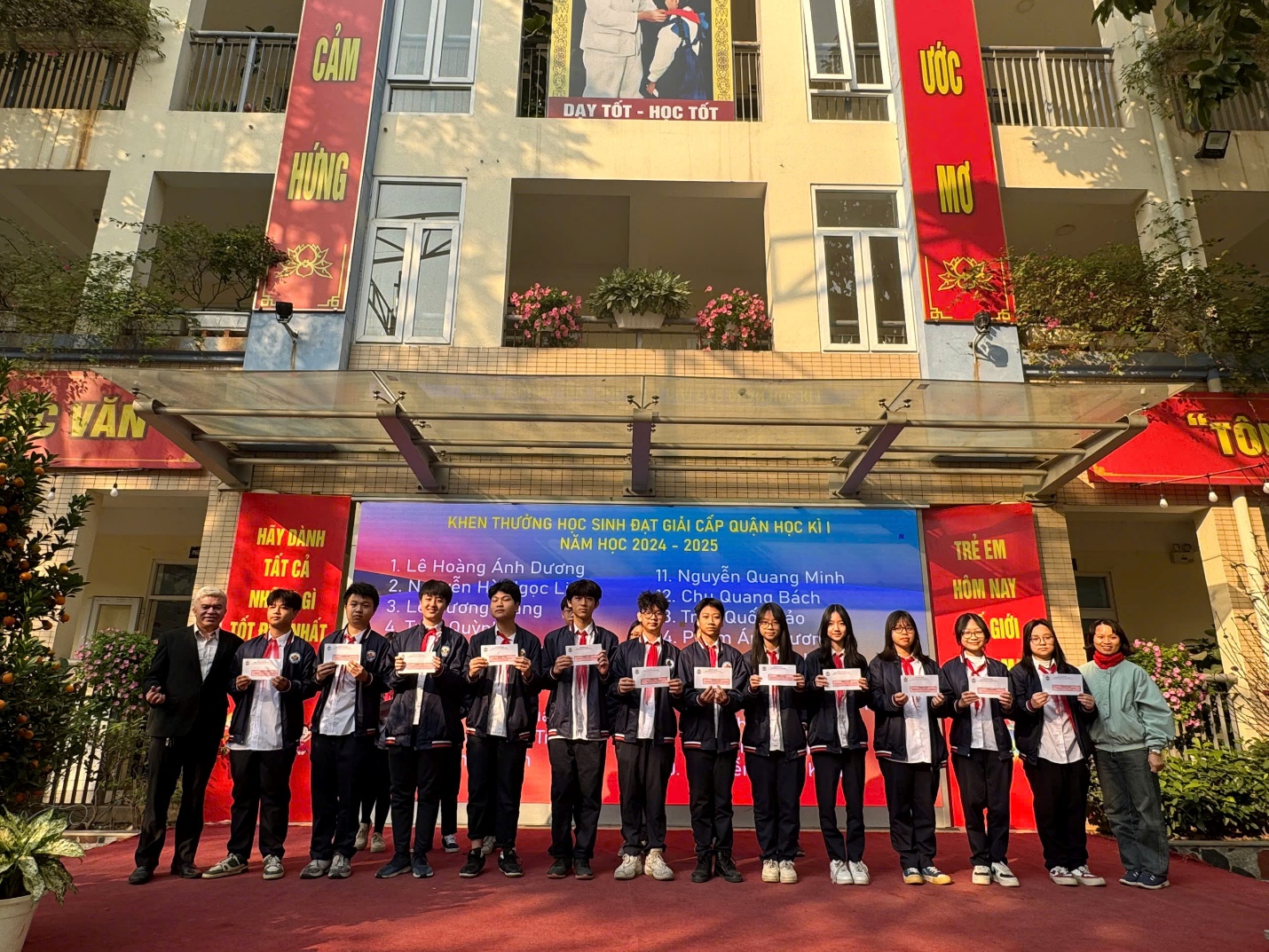 A group of people standing in front of a buildingDescription automatically generated