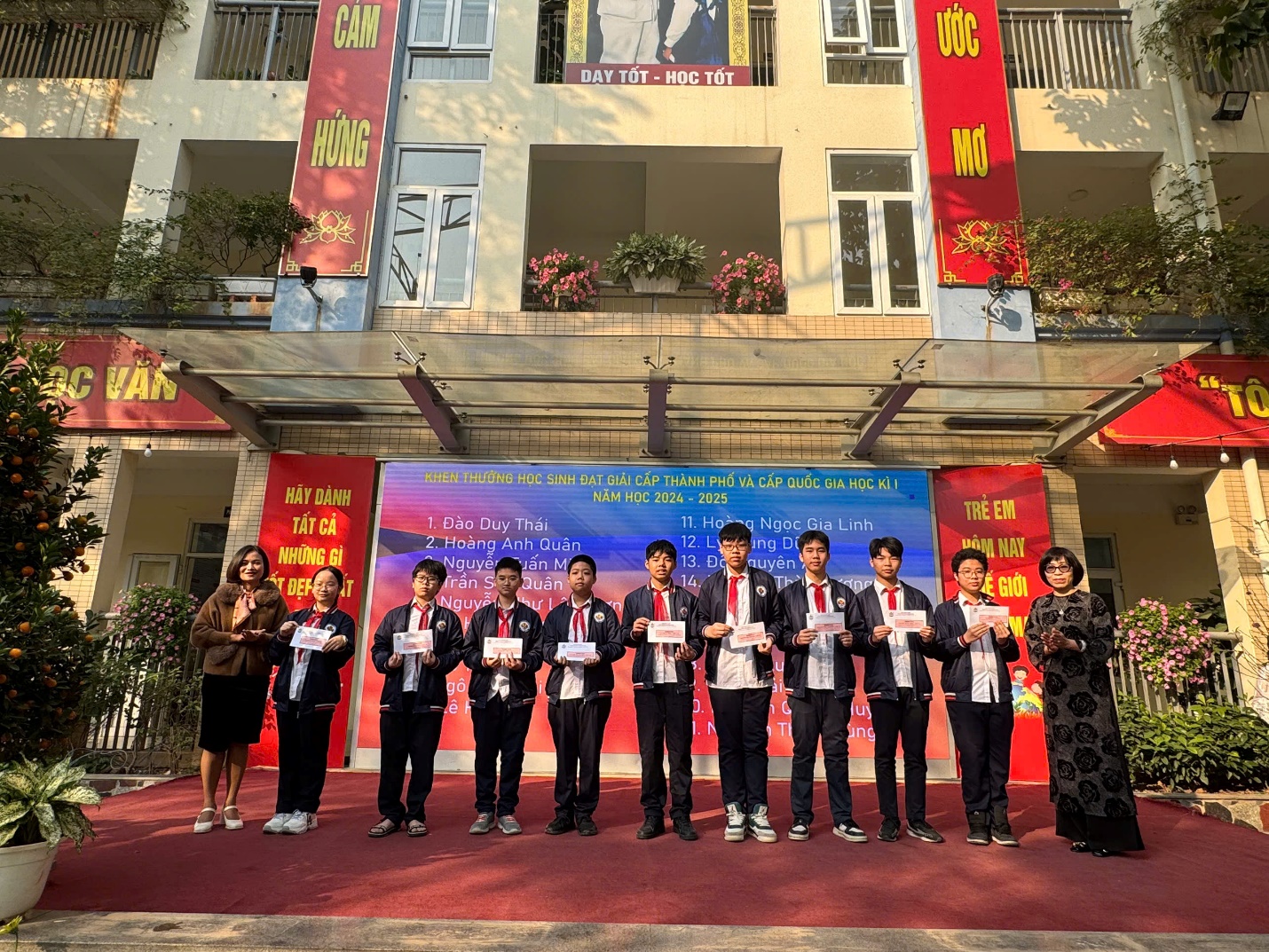 A group of people standing in front of a buildingDescription automatically generated