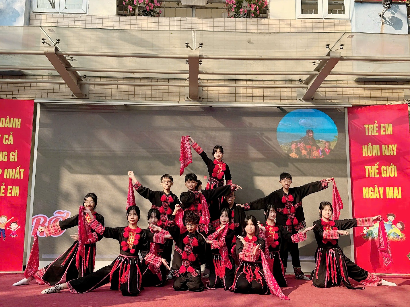 A group of people wearing black and red outfitsDescription automatically generated