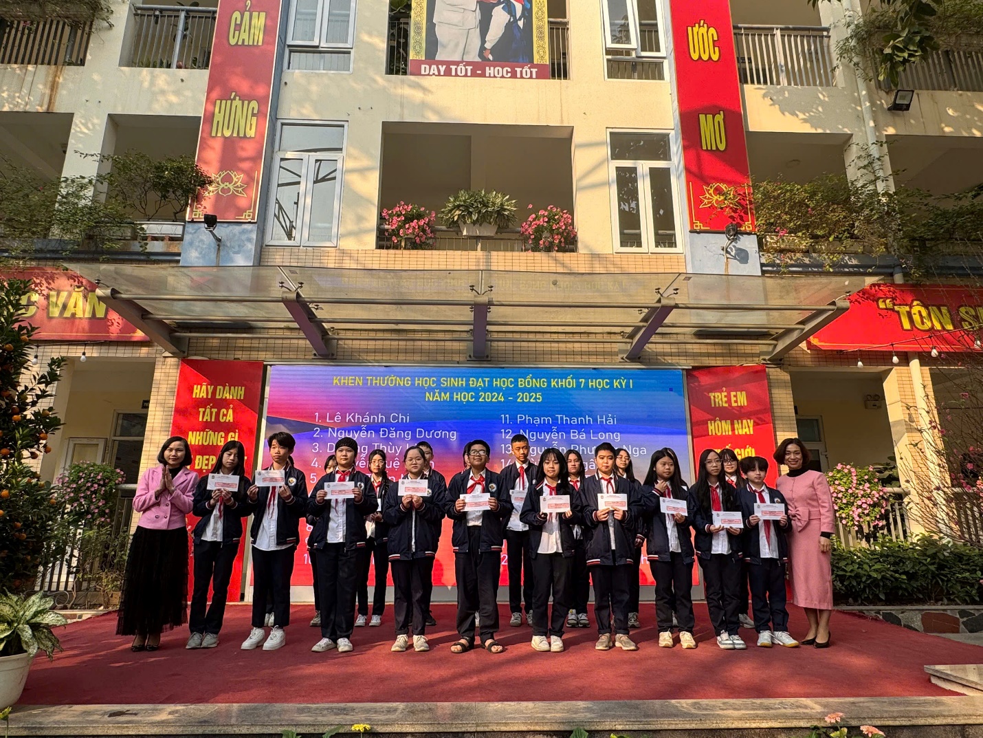 A group of people standing in front of a buildingDescription automatically generated