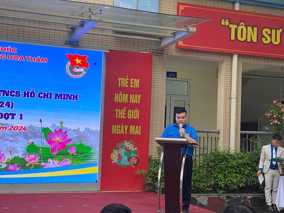 A person standing at a podium with a microphoneDescription automatically generated