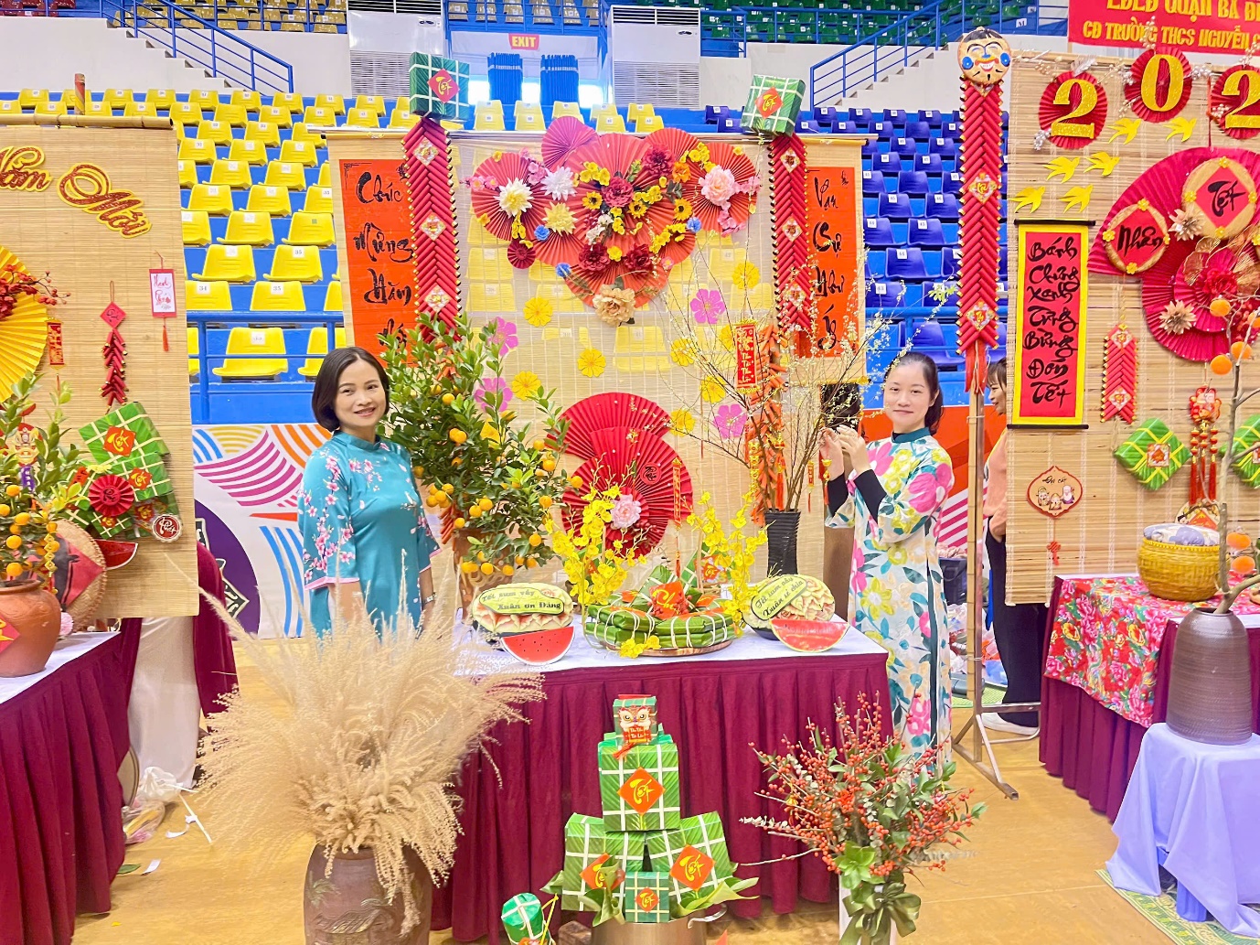 A group of women standing in front of a table with flowersDescription automatically generated