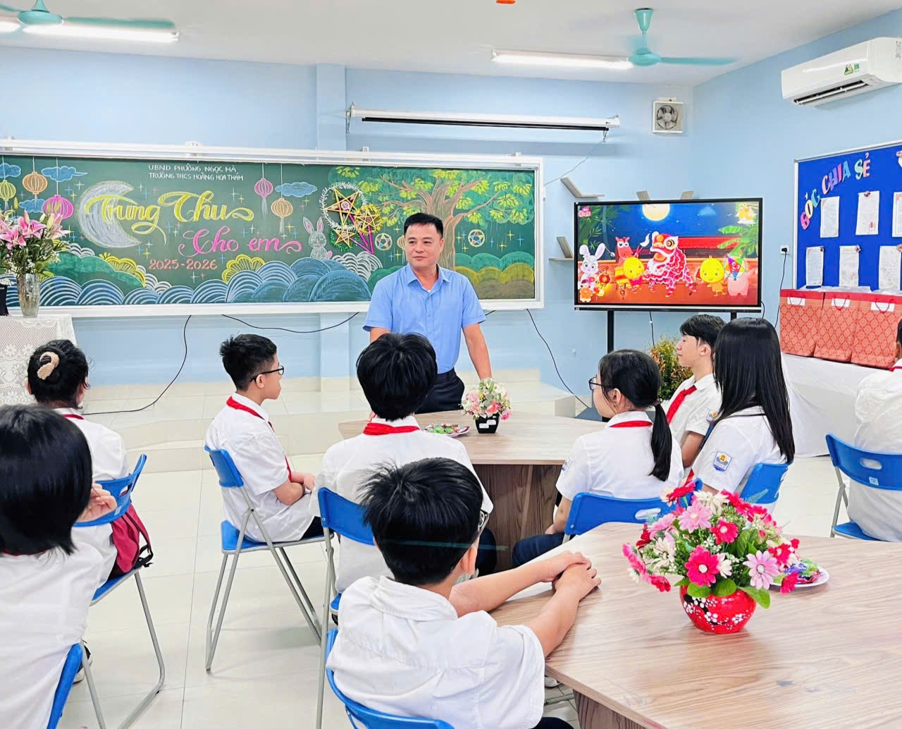 A person standing in front of a group of studentsDescription automatically generated