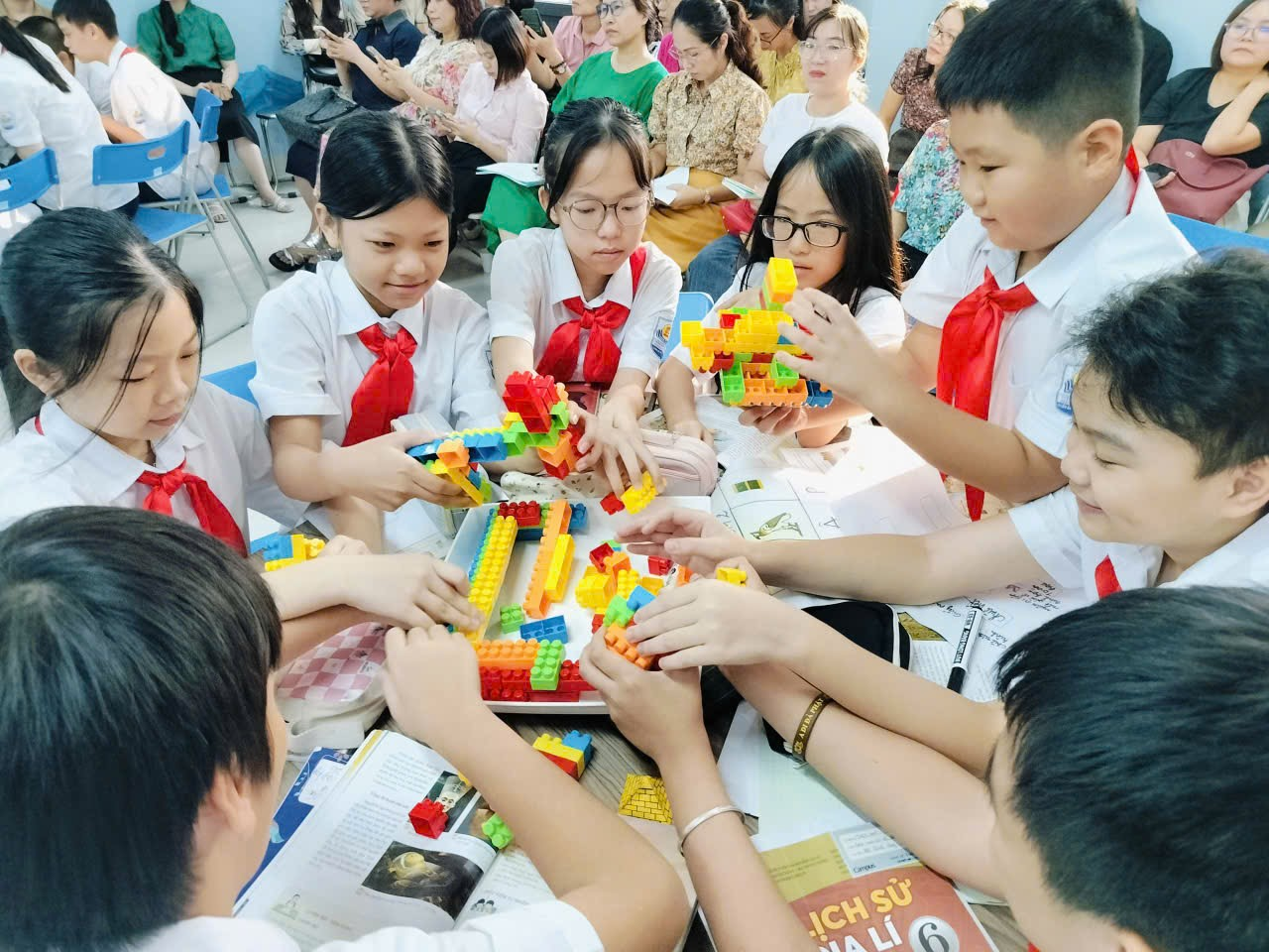 A group of children playing with blocks
Description automatically generated