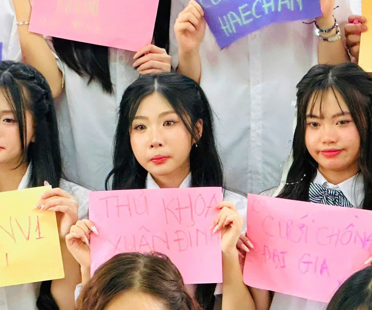 A group of women holding signs

AI-generated content may be incorrect.