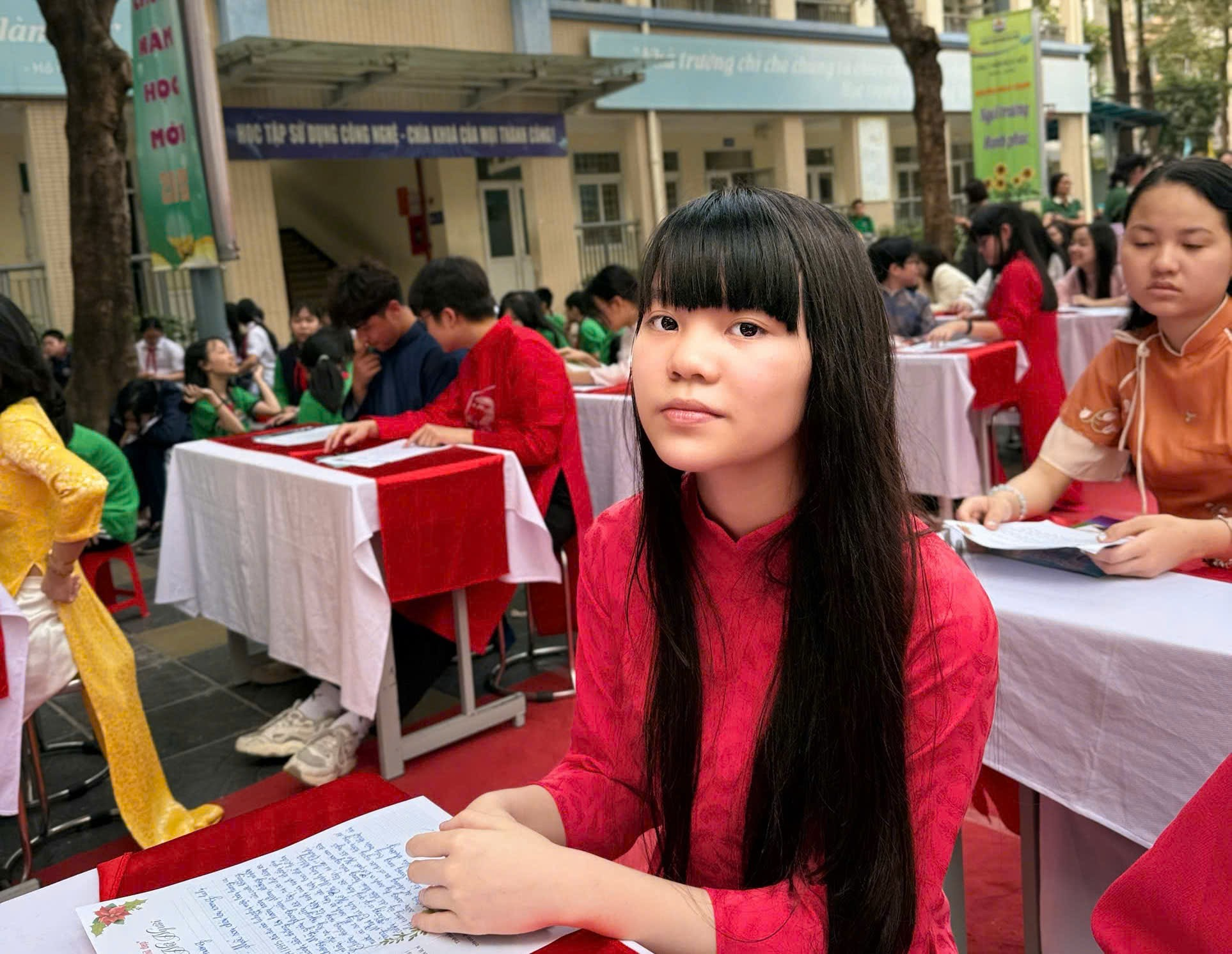 A child sitting at tables with other people in the background

AI-generated content may be incorrect.