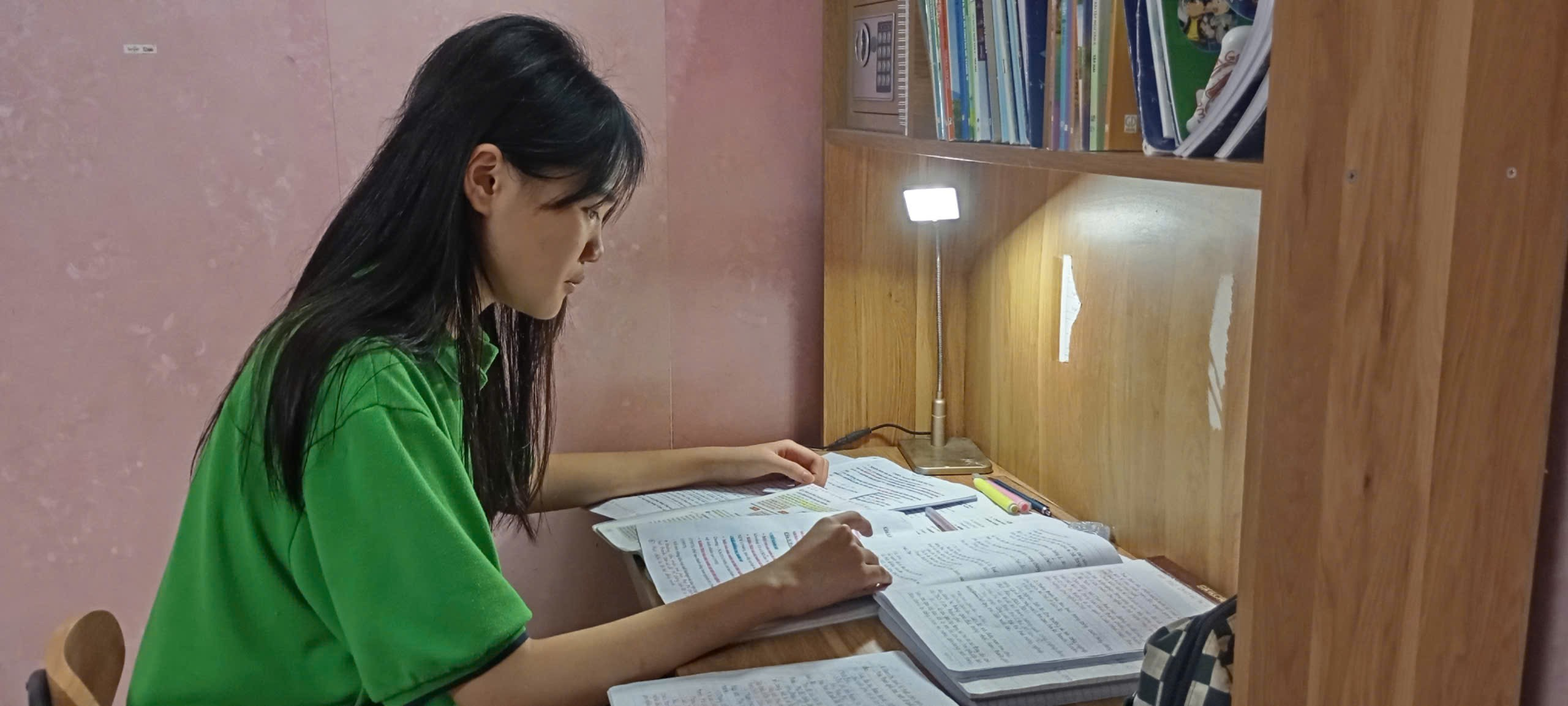 A person sitting at a desk with books

AI-generated content may be incorrect.