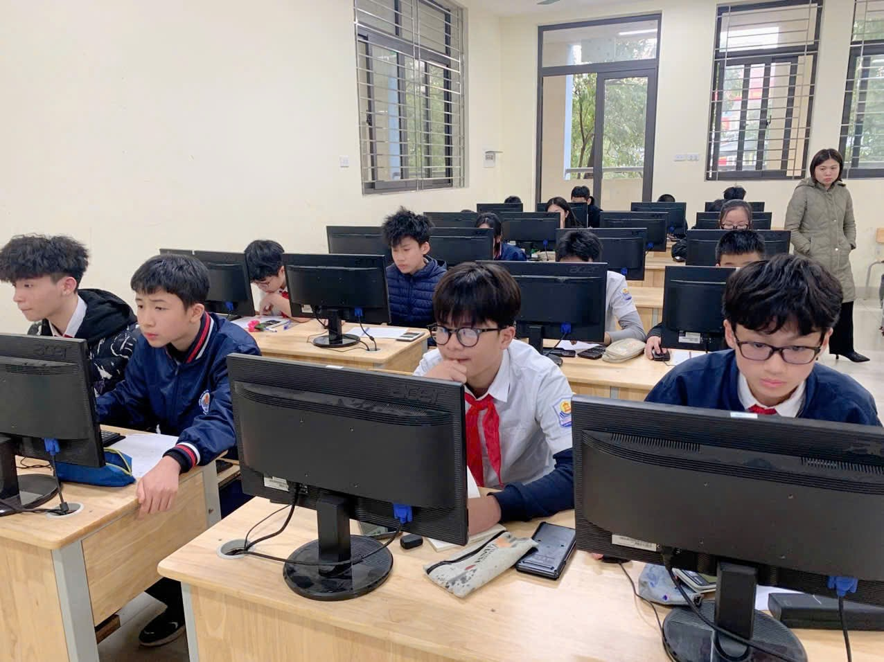 A group of people sitting at computers

AI-generated content may be incorrect.