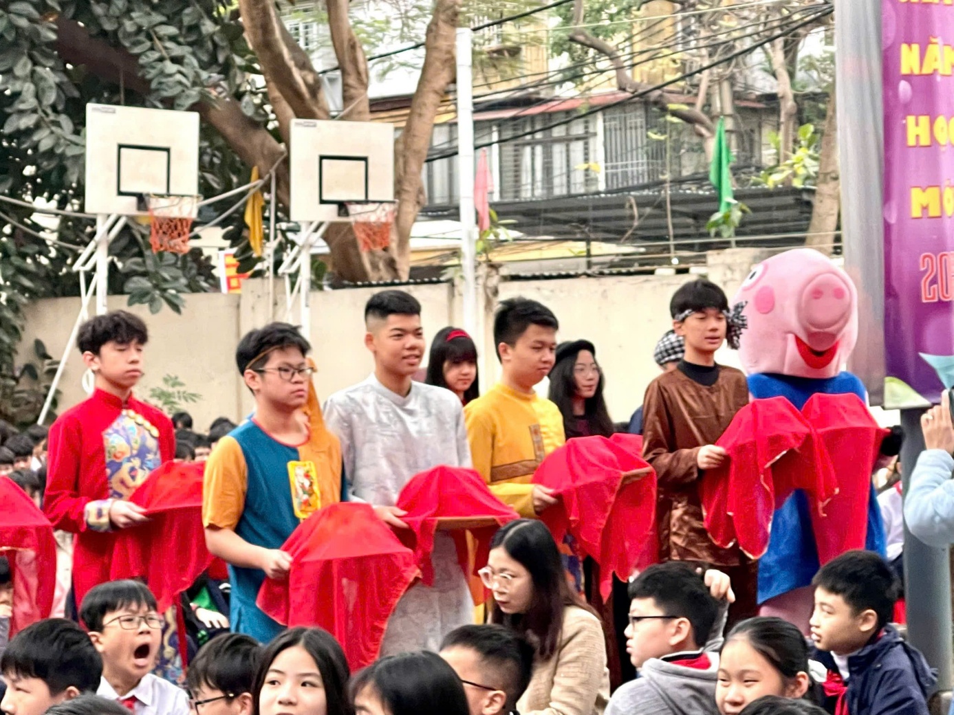A group of people standing in a circle with a person in garment

Description automatically generated