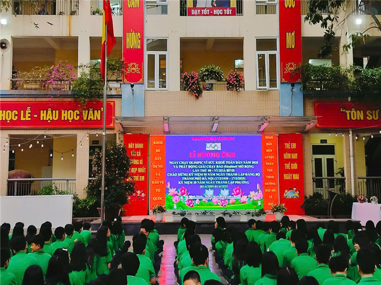 A group of people in green shirts

Description automatically generated