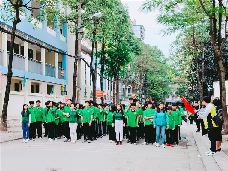 A group of people in green shirts

Description automatically generated