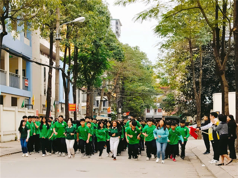 A group of people in green shirts

Description automatically generated
