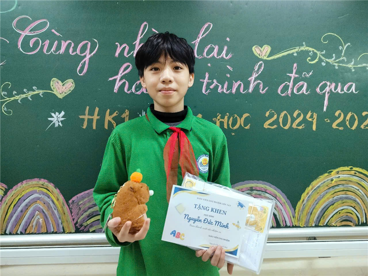 A child holding a stuffed animal and a certificate in front of a chalkboard

Description automatically generated