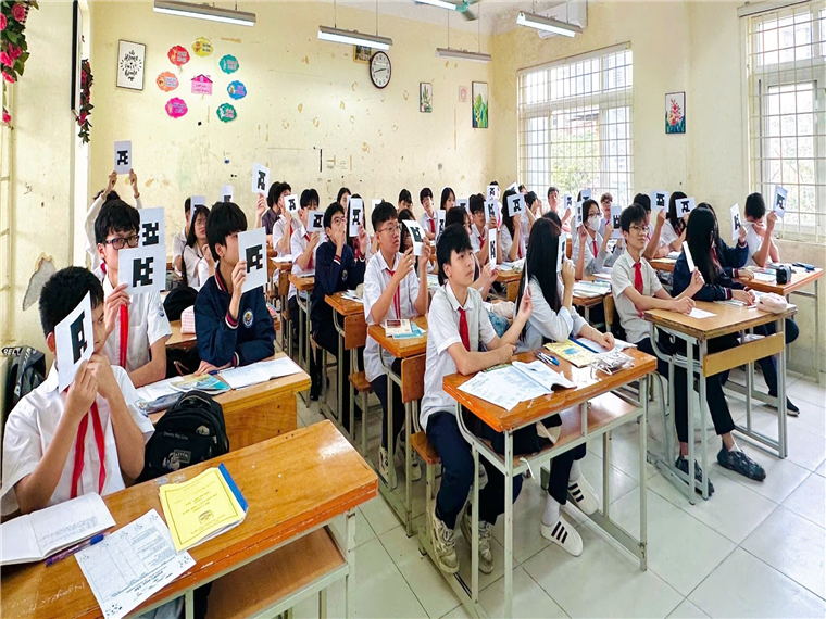 A group of students sitting at desks in a classroom

AI-generated content may be incorrect.