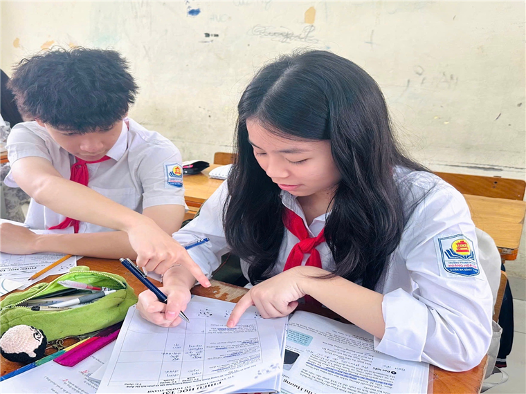 A child and child sitting at a desk looking at papers

AI-generated content may be incorrect.