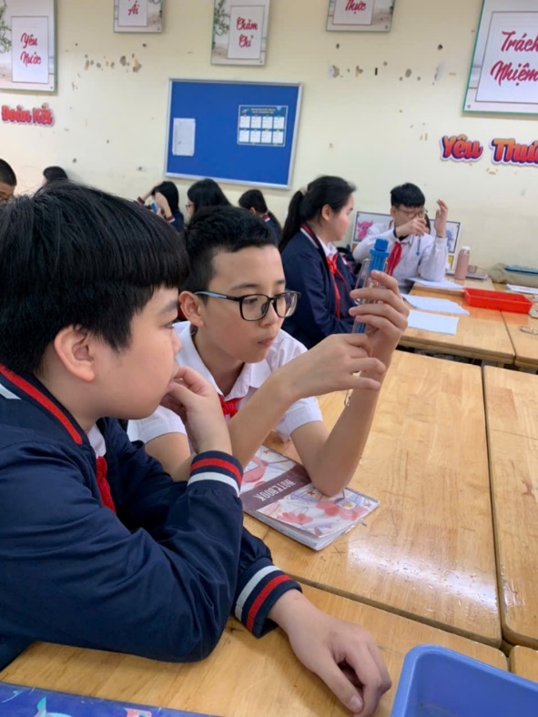 A group of students sitting at a desk

AI-generated content may be incorrect.