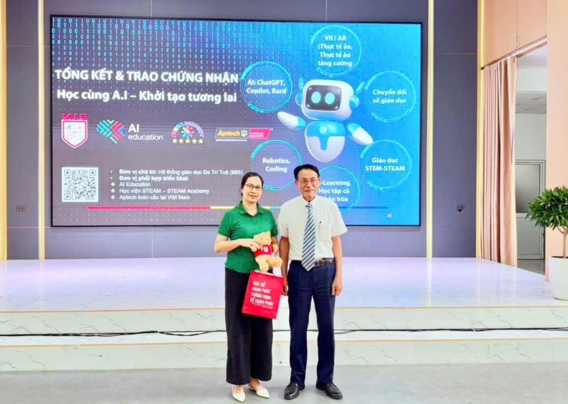 A person and person standing in front of a large screen

Description automatically generated