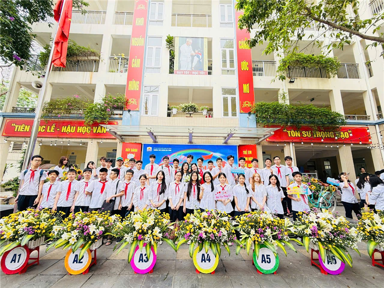 A group of people in white shirts and red ties posing for a photoAI-generated content may be incorrect.