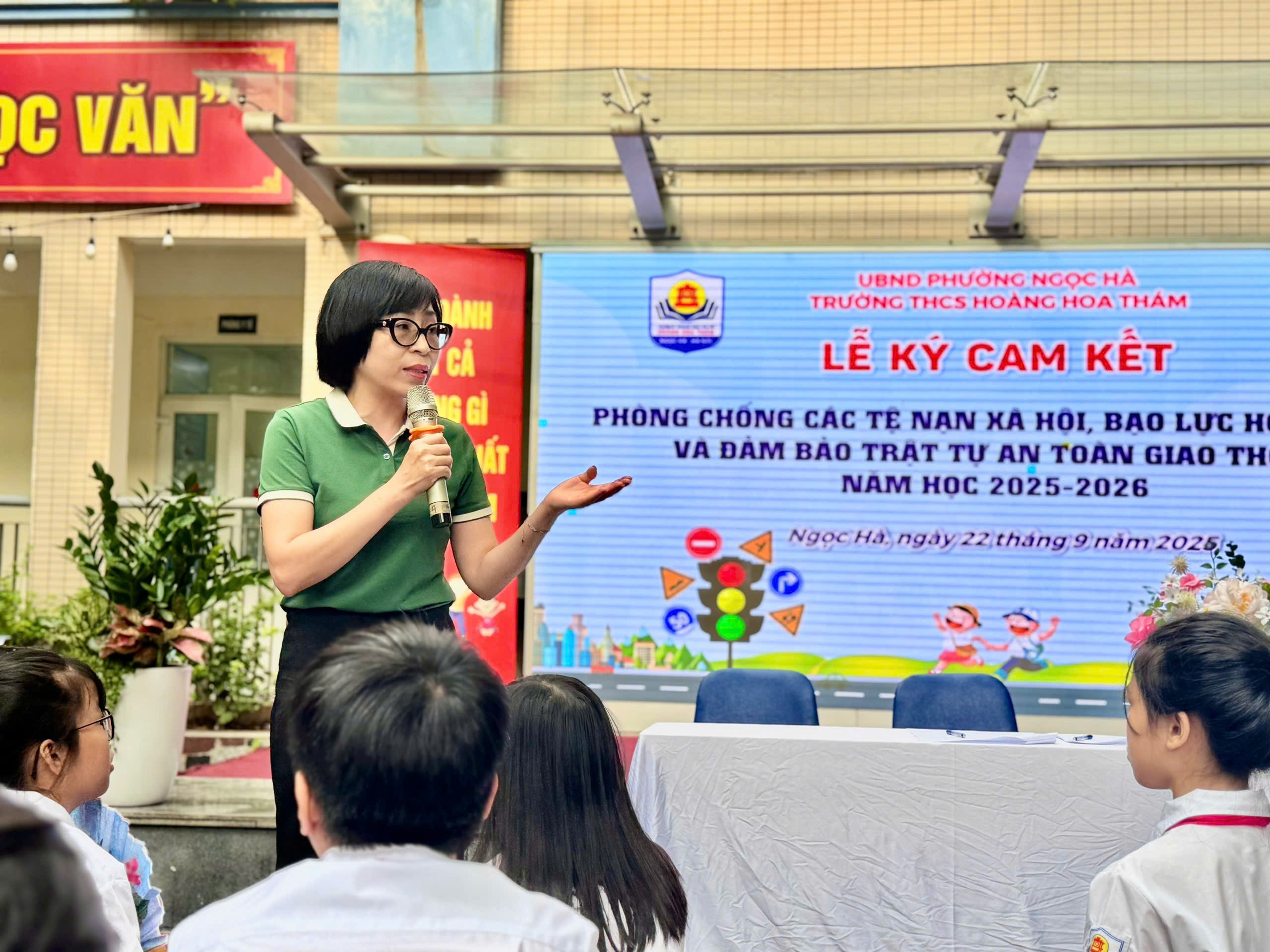 A person standing in front of a large screen
Description automatically generated