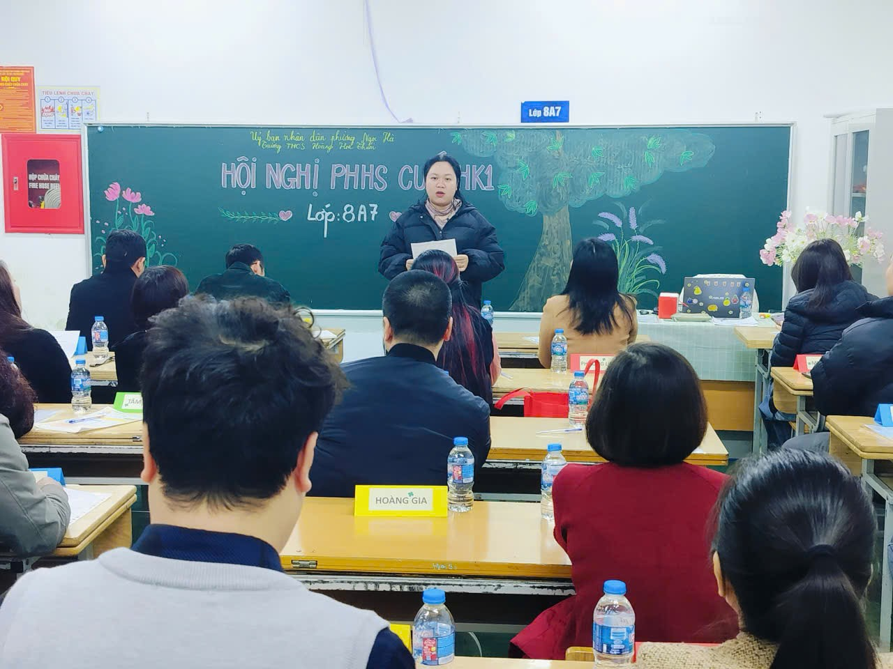 A person standing in front of a chalkboard

Description automatically generated