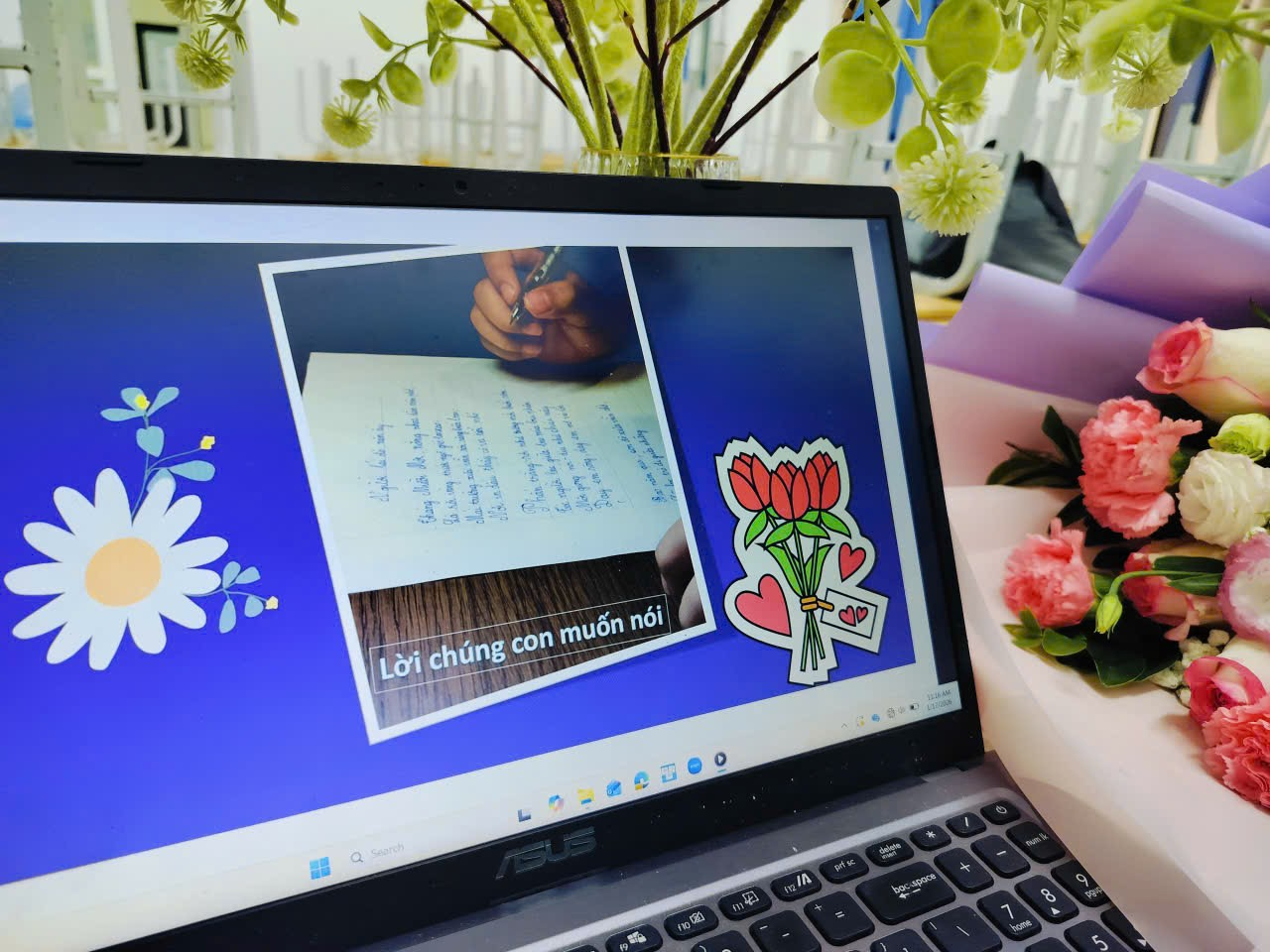 A computer with a picture of a note and flowers

Description automatically generated