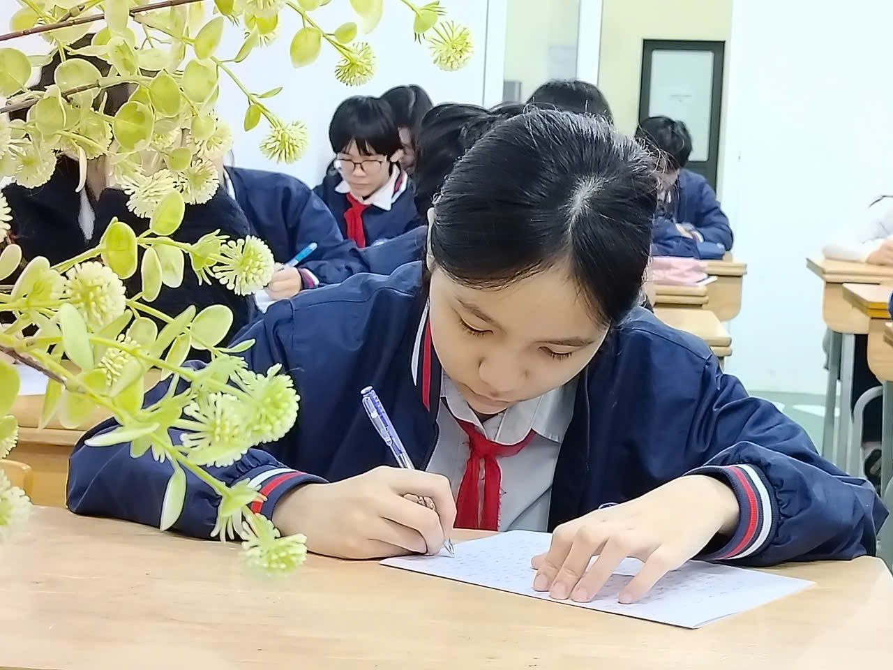 A child writing on a piece of paper

Description automatically generated