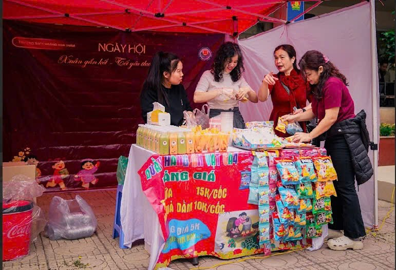 A group of women standing around a table with food

Description automatically generated