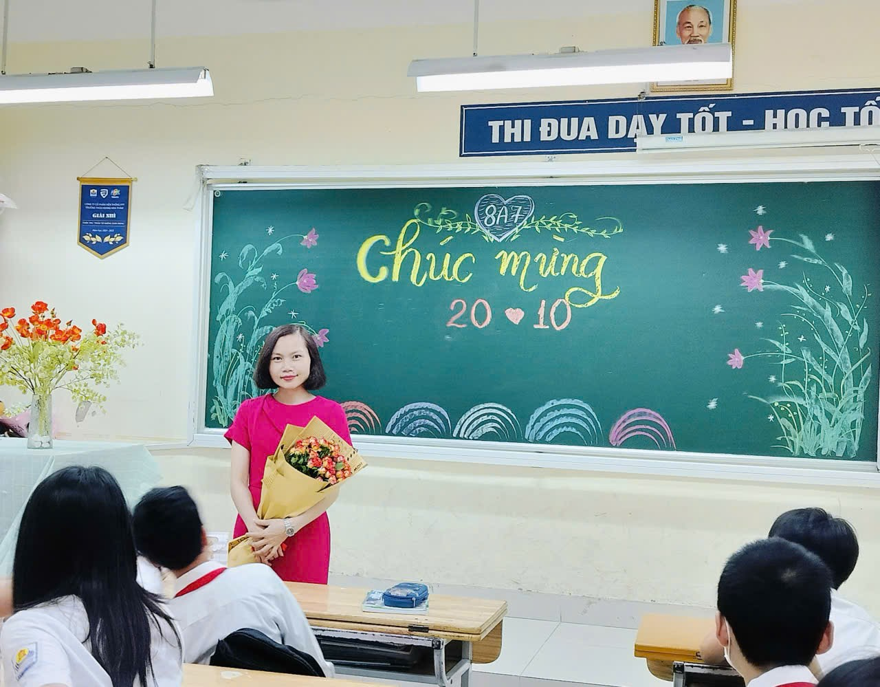 A person standing in front of a chalkboard
Description automatically generated