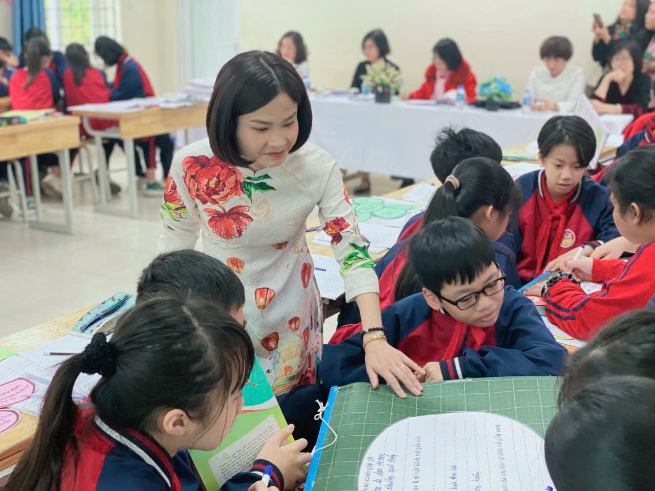 A person standing in front of a group of children

Description automatically generated