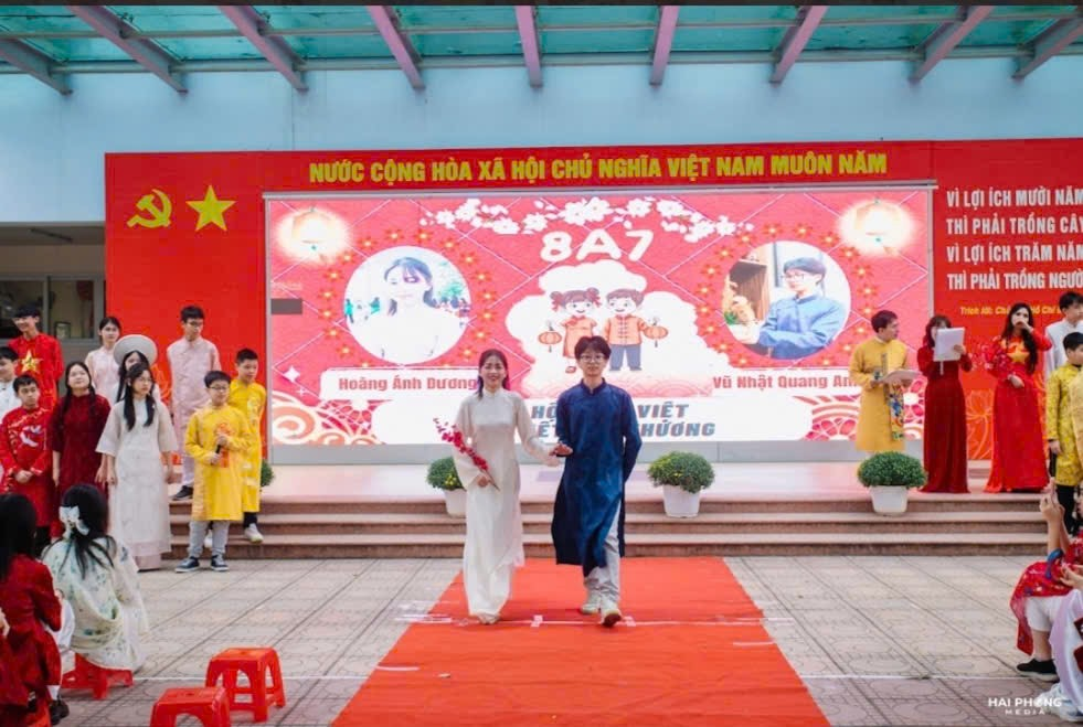 A group of people walking on a red carpet
Description automatically generated