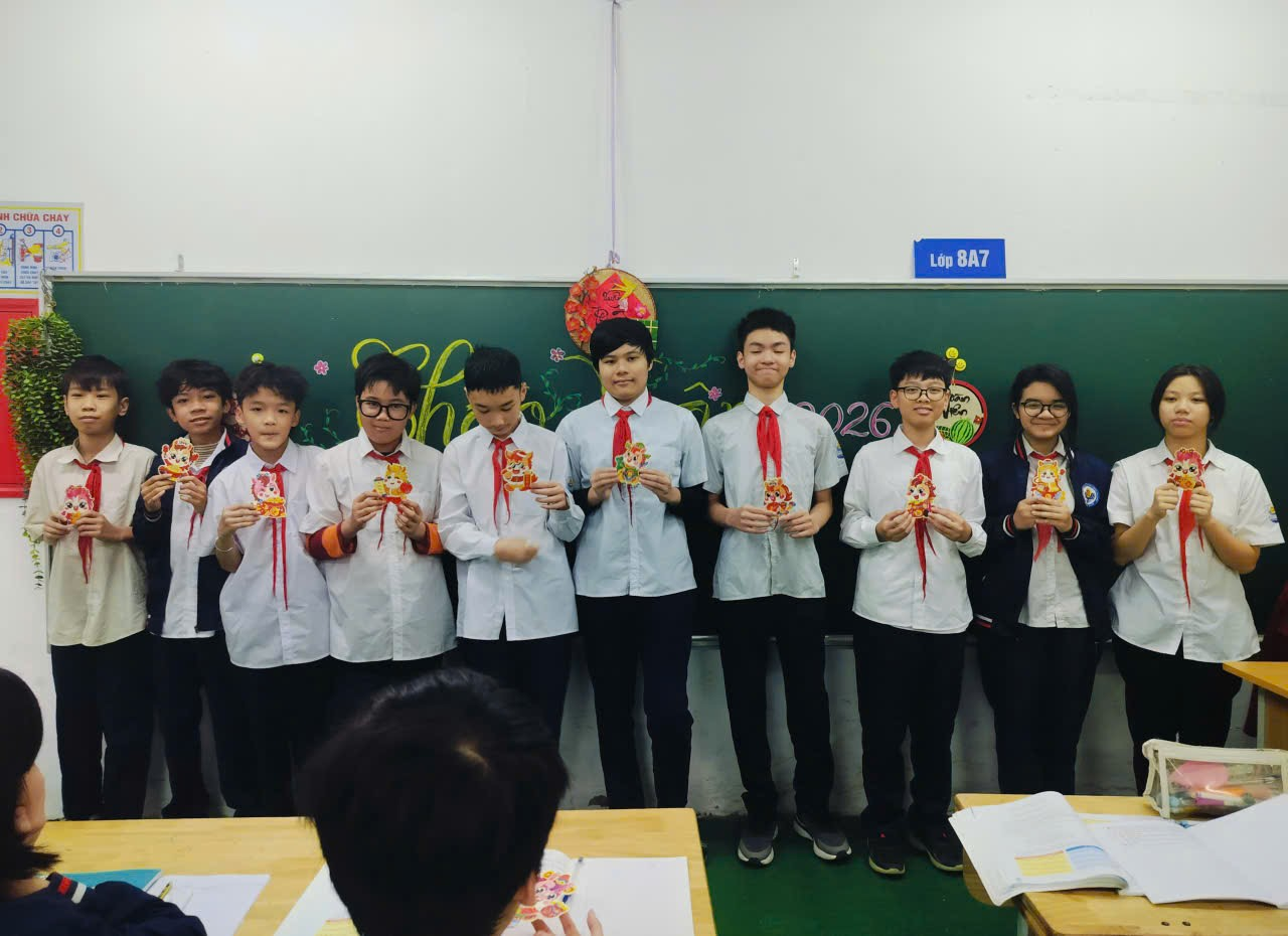 A group of people standing in a classroom
Description automatically generated