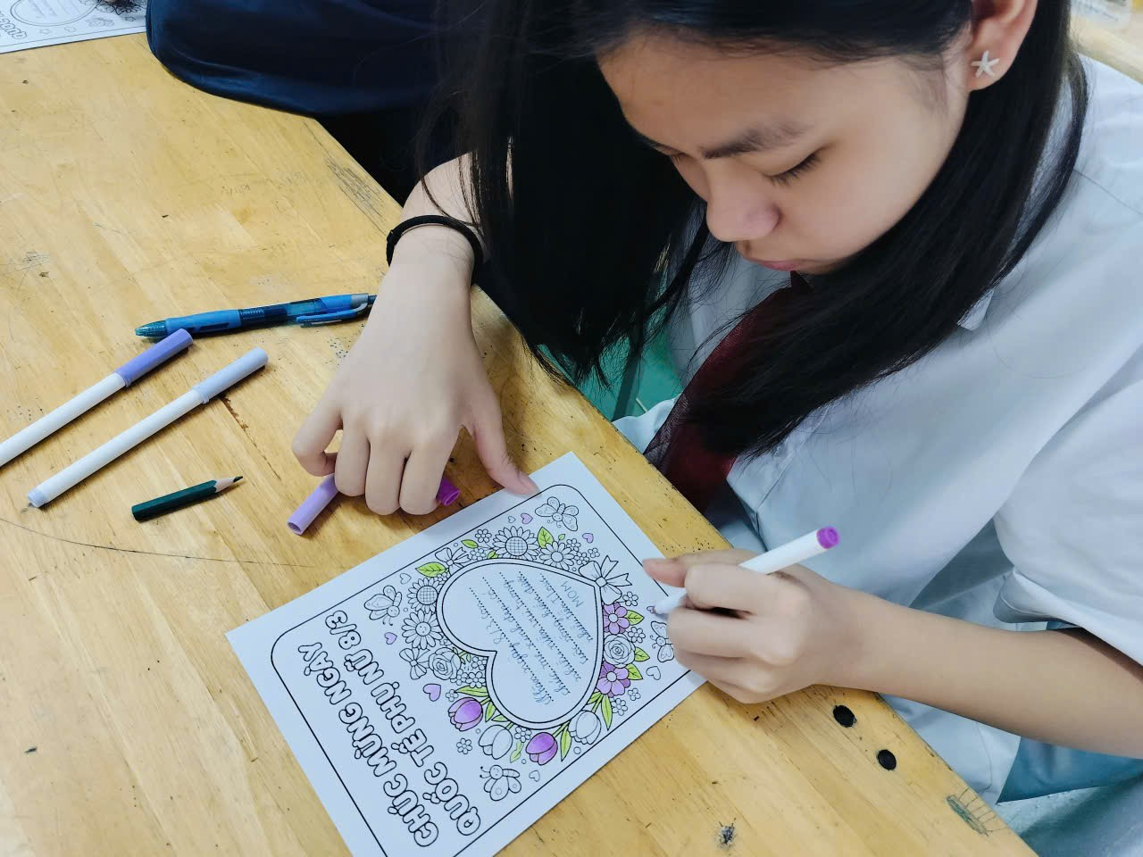 A child coloring a piece of paper
Description automatically generated
