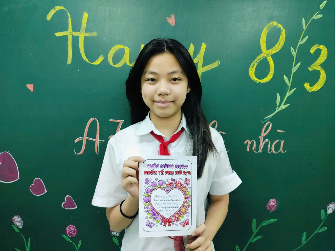 A child holding a piece of paper
Description automatically generated