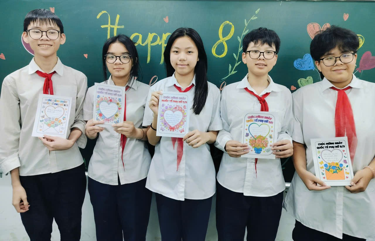 A group of people holding up posters
Description automatically generated