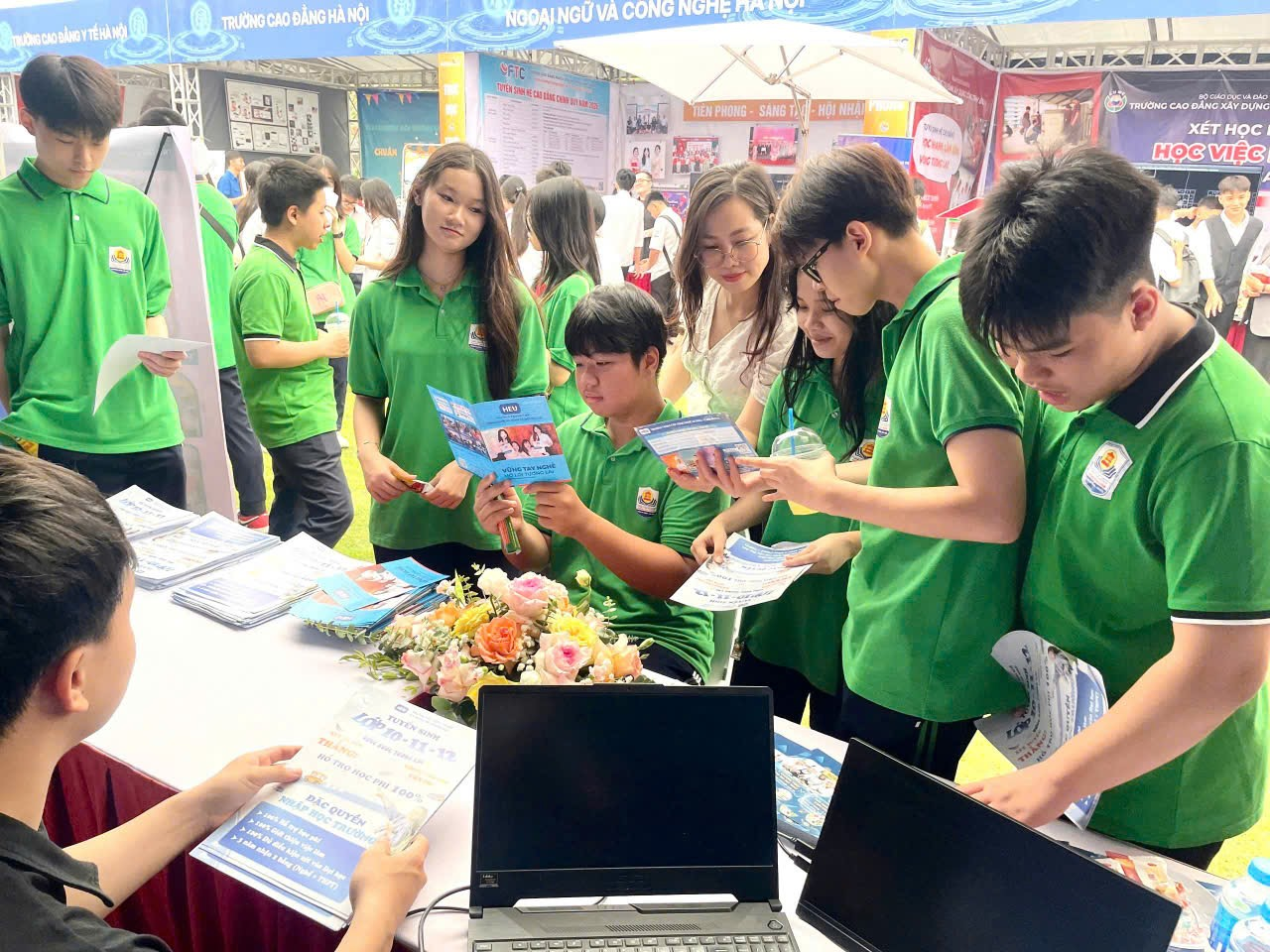 A group of people in green shirts

Description automatically generated