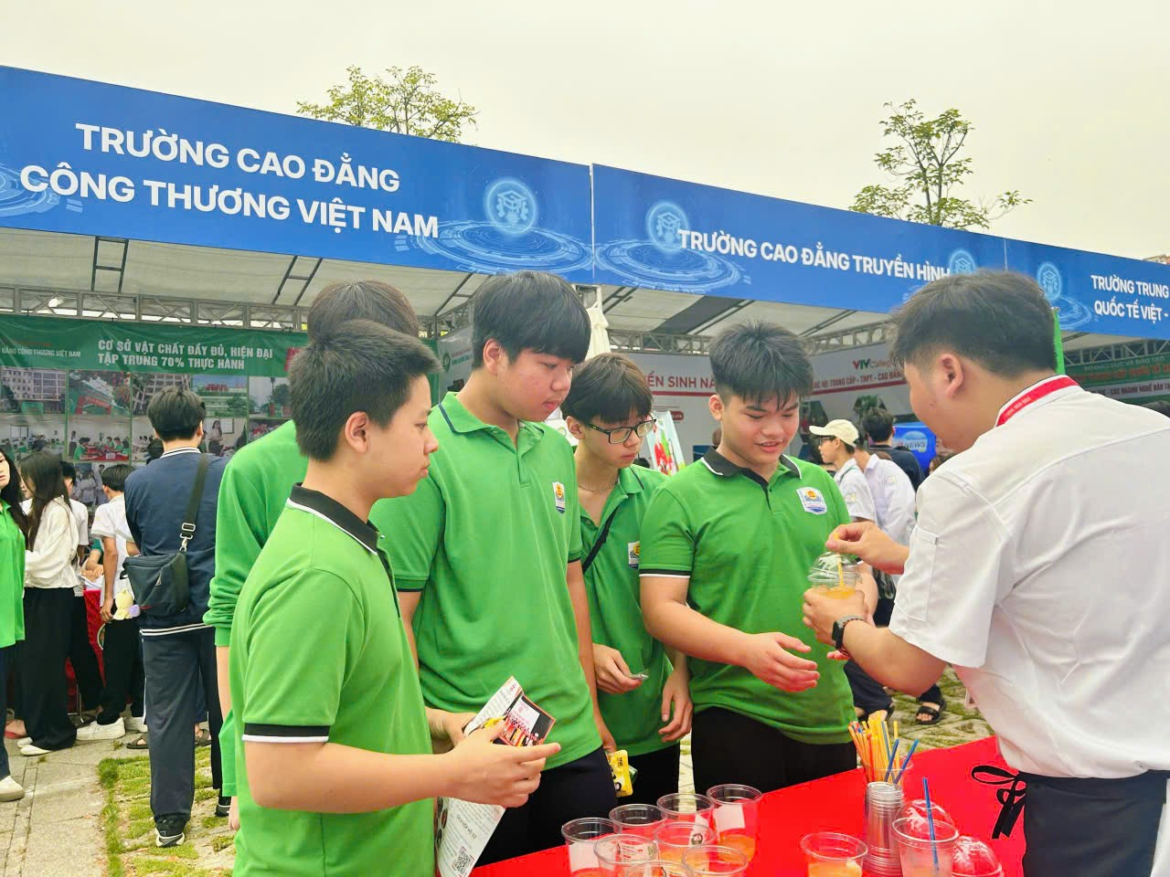 A group of people standing around a table

Description automatically generated