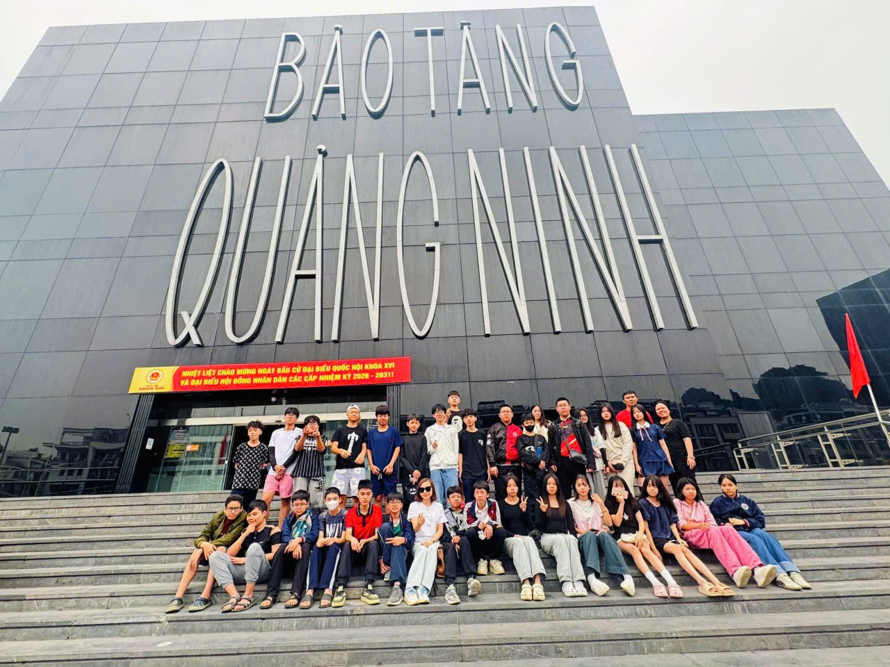 A group of people posing for a photo
Description automatically generated