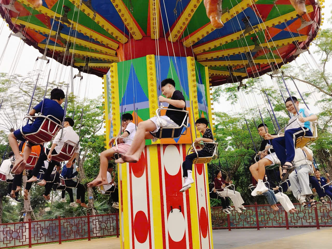 A group of people on swings
Description automatically generated