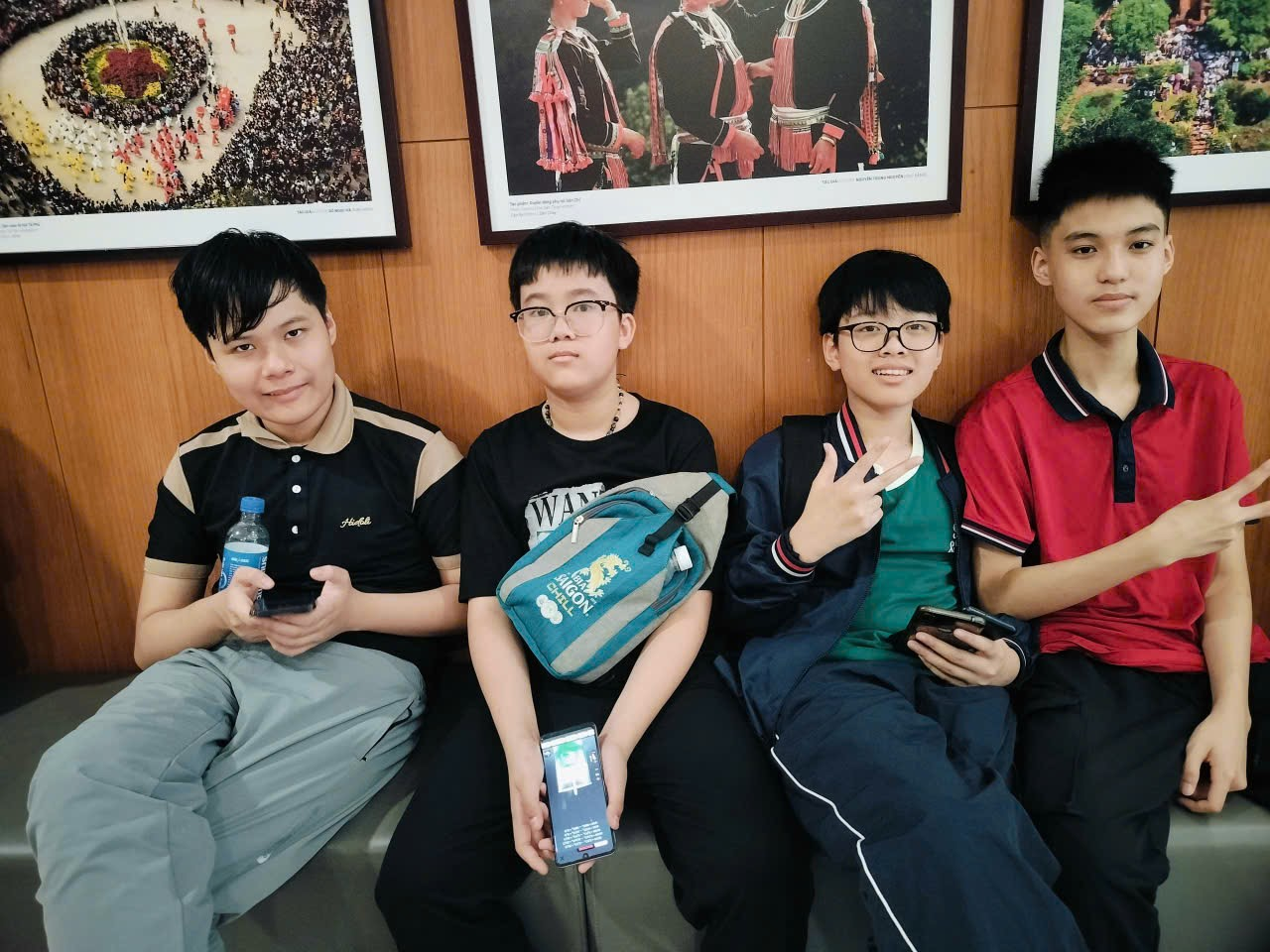 A group of boys sitting on a bench
Description automatically generated