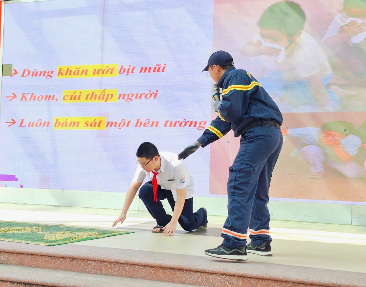 A person kneeling on the ground with a police officerDescription automatically generated