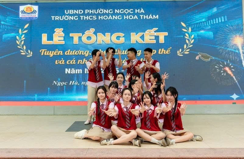 A group of people posing for a photo
Description automatically generated