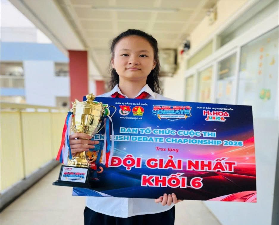 A child holding a trophy and a trophyDescription automatically generated