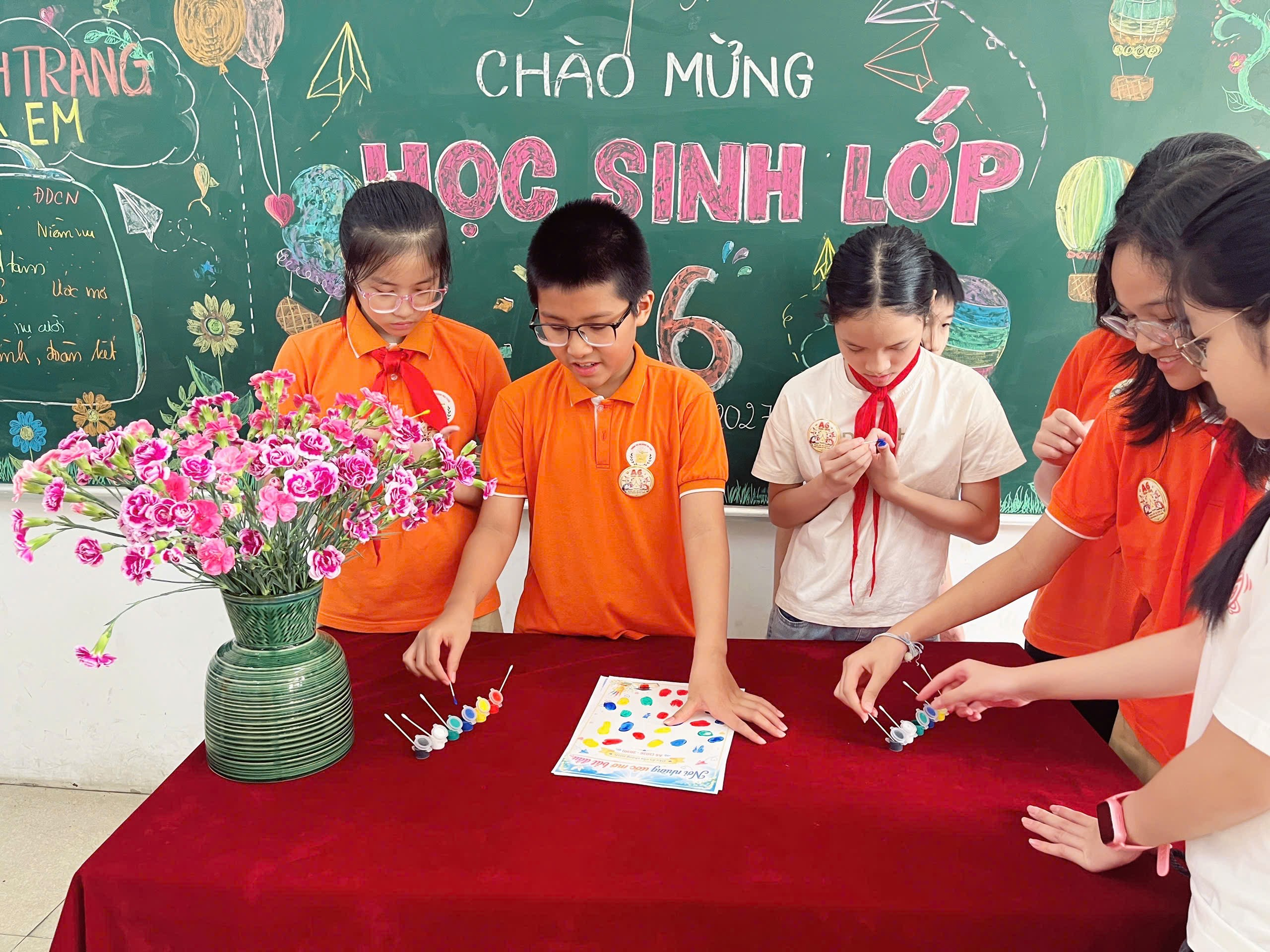 A group of children in orange shirts

Description automatically generated